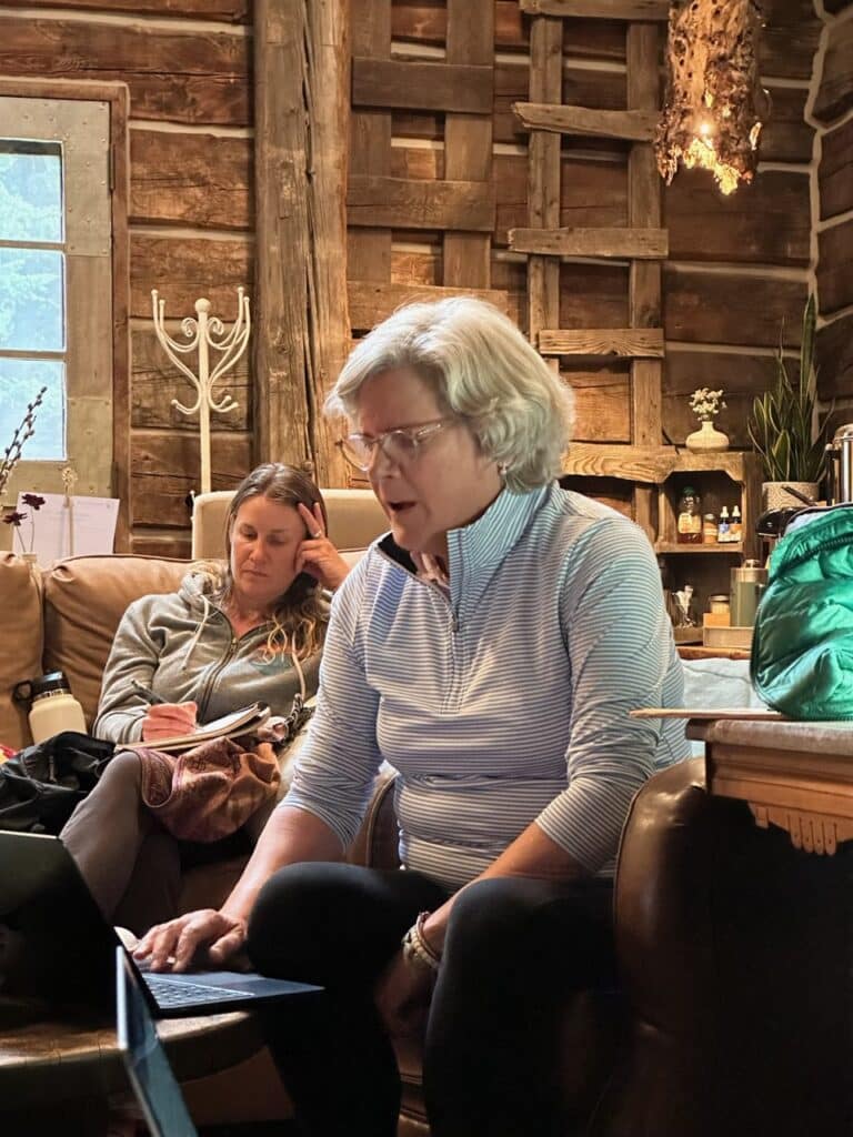 writer sharing work in front of group at the haven 2 writing retreat