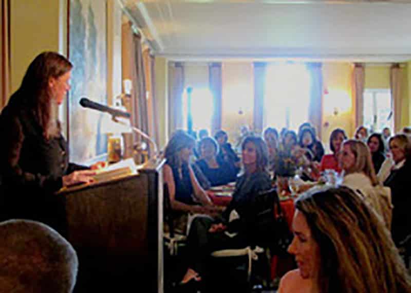 Laura Munson reads from her book in a room full of people