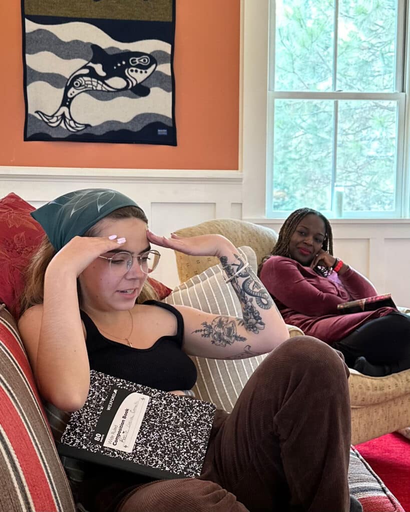 A women putting her hands on her head engaged during the Haven 1 Writing Retreat